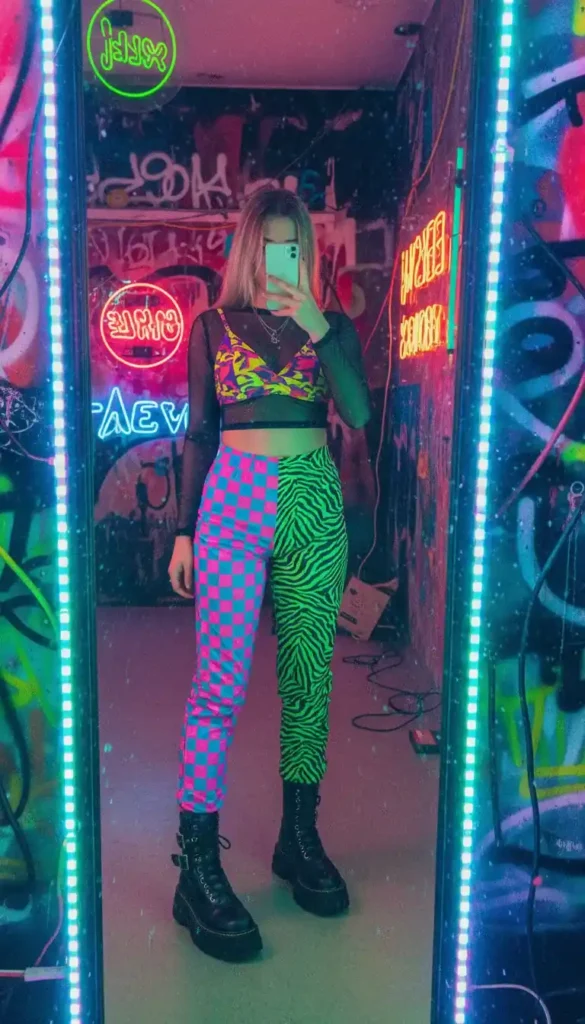 "Wasteland scavenger look in 16 Cyberpunk Outfit Ideas: worn leather vest, cargo pants, post-apo ruins"