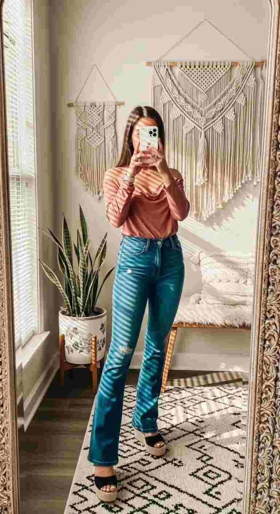 Boho birthday photo shoot outfit with jeans — rust off-shoulder top, flare blue jeans, and black platform sandals