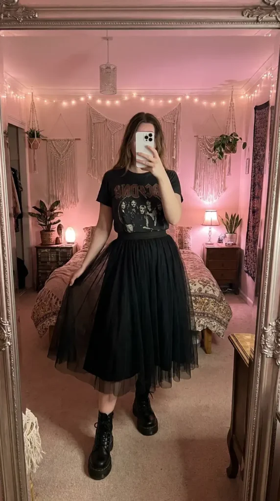 Black concert outfit ideas for women: AC/DC graphic tee with black tulle midi skirt and chunky lace-up boots