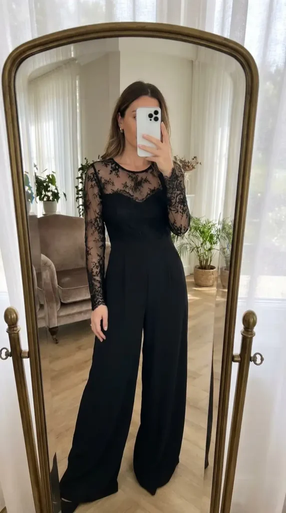 Black classy wedding guest jumpsuit summer with floral lace sleeves and wide-leg pants.
