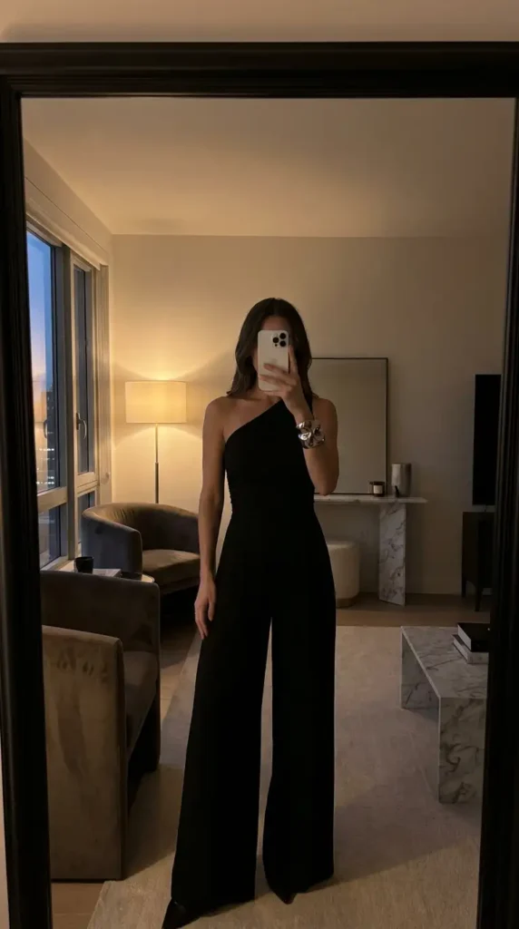 Black classy wedding guest jumpsuit summer with one-shoulder asymmetrical wide-leg design.
