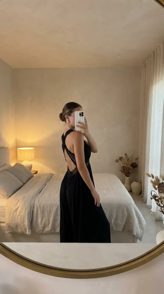 Black classy wedding guest jumpsuit summer with open back lace detail and pleated wide legs.
