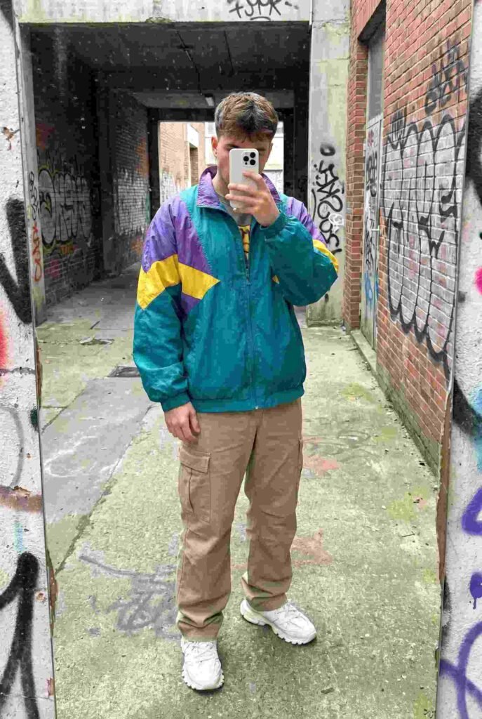 Bold windbreaker paired with cargo pants — a functional, retro-inspired 90s style outfit idea for men on the go
