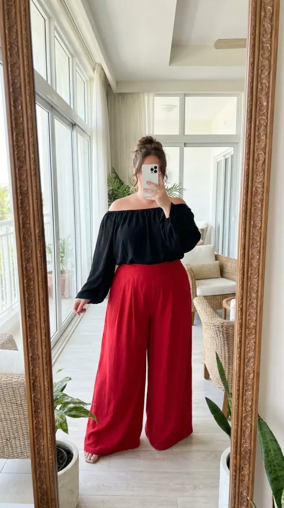Red and black outfit ideas for plus size: black off-shoulder top styled with flowy red wide-leg palazzo pants.
