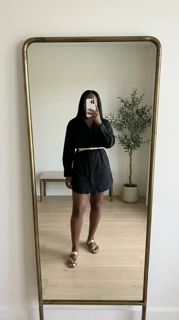 Relaxed black shirt dress styled with gold belt and sandals, versatile black and gold outfit ideas for black women.