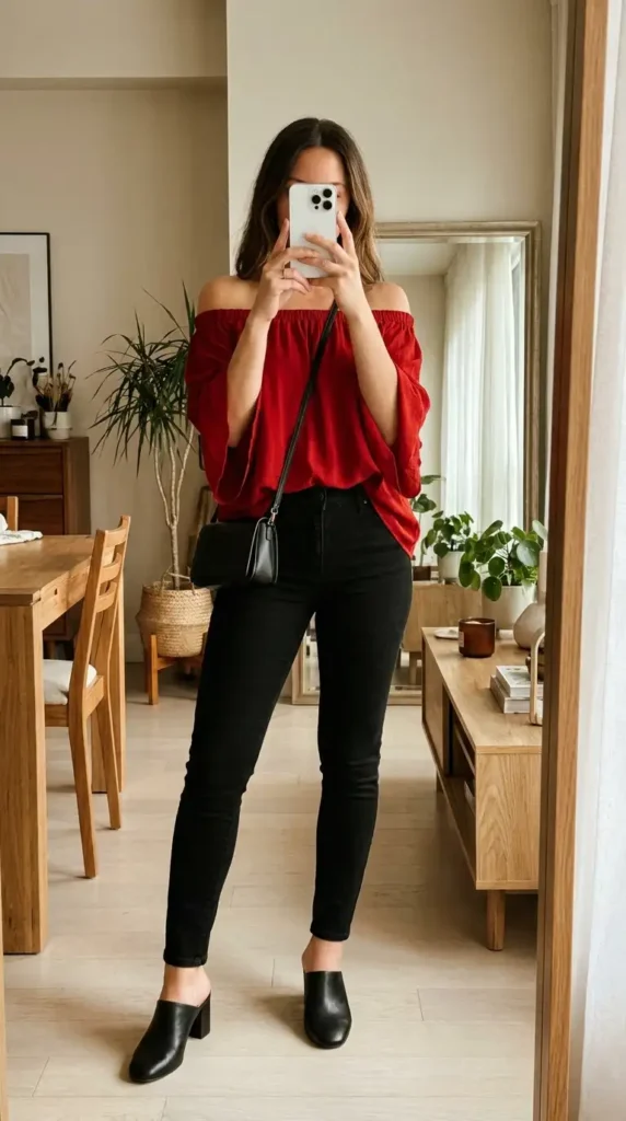 Red off-shoulder blouse with black skinny jeans and mules, a casual red and black outfit idea for party outings.
