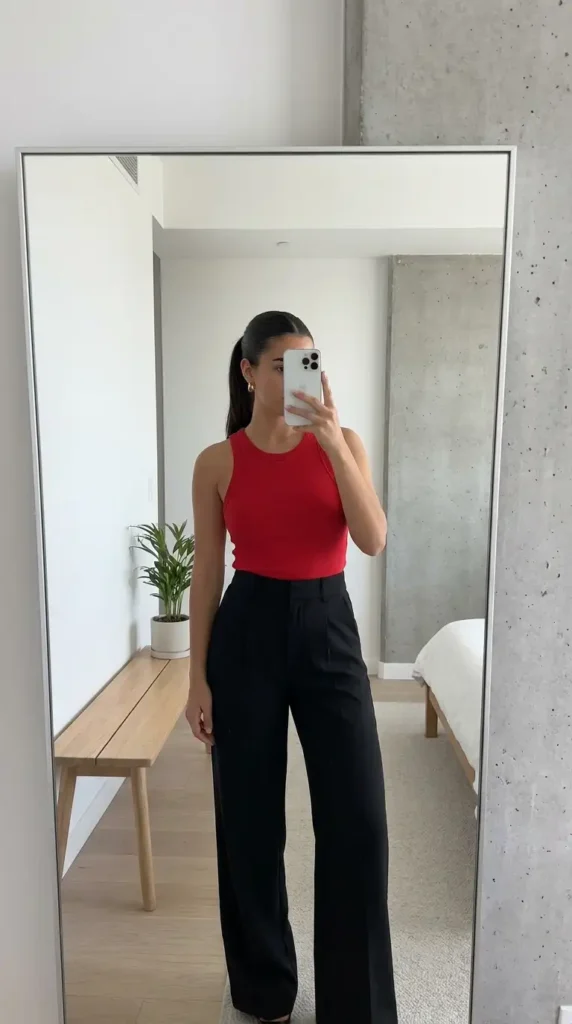 Clean red & black summer outfits: red racerback tank tucked into high-waist black wide-leg tailored trousers
