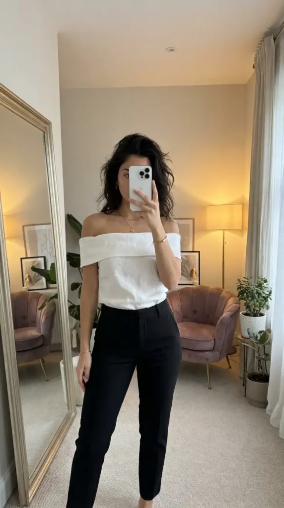 White off-shoulder top with black cigarette pants — a chic and understated black and white formal outfit idea.
