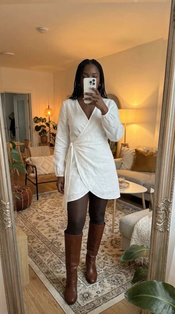 White wrap dress and tall brown boots – stylish All White Fall Outfit Ideas for Black Women.