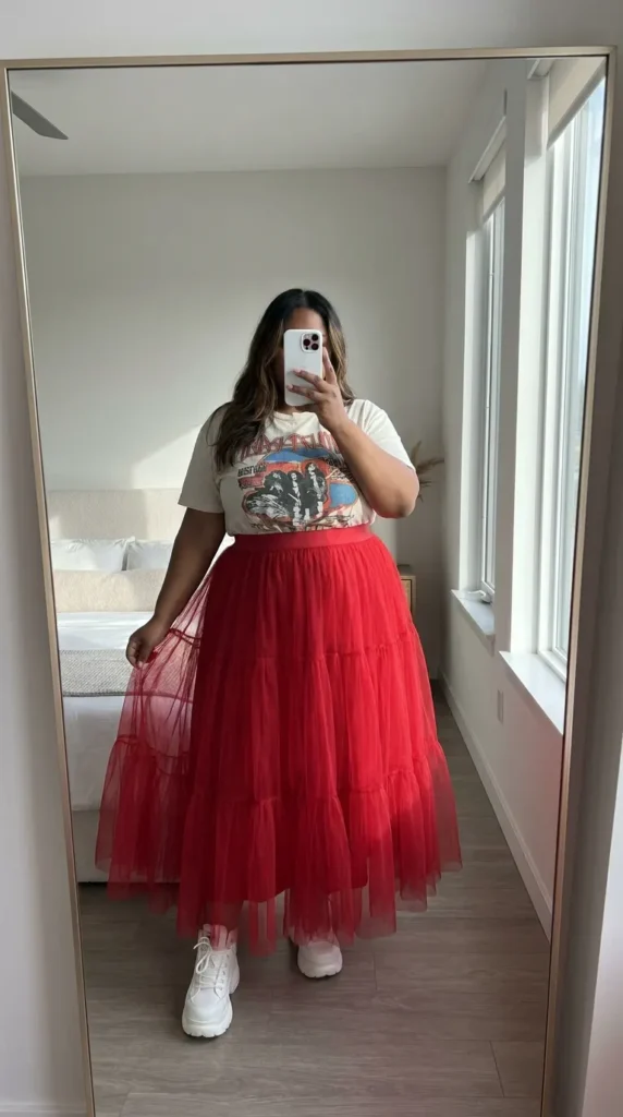 Plus size woman in graphic tee with long red tulle skirt, fun Long Red Skirt Outfit Ideas for Plus Size women