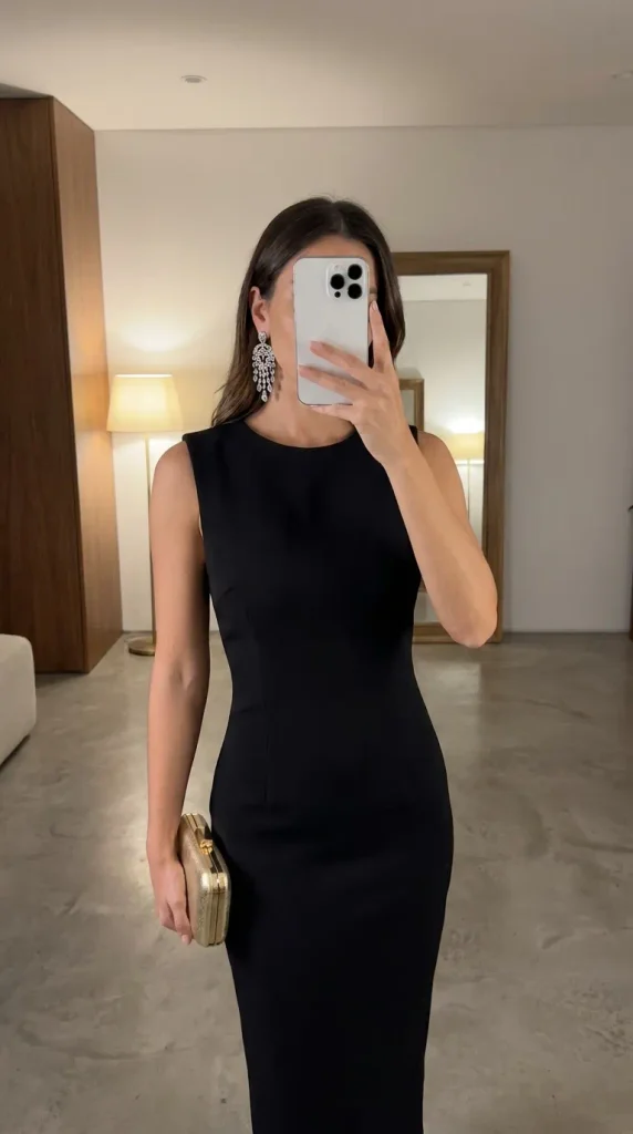 Classic New Year Eve Outfit Ideas for Women in a sleek black dress with statement earrings.
