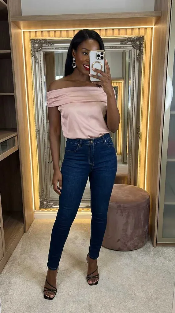 Elegant New Year Eve Outfit Ideas for Women in soft pink off-shoulder top with dark skinny jeans.