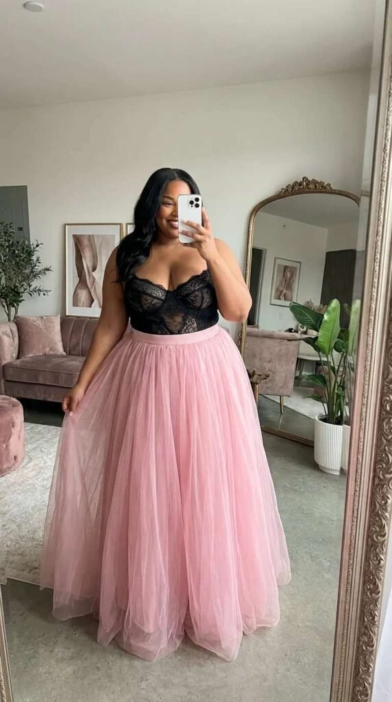 Plus size woman in black lace top and pink tulle skirt, glam All Pink Outfit Ideas for Plus Size women look.