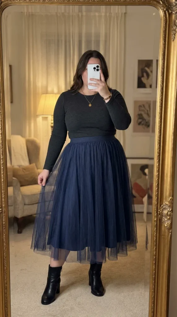 Curvy woman in dark top and navy tulle midi skirt with ankle boots, playful New Year Eve Outfit Ideas for Plus Size Women.